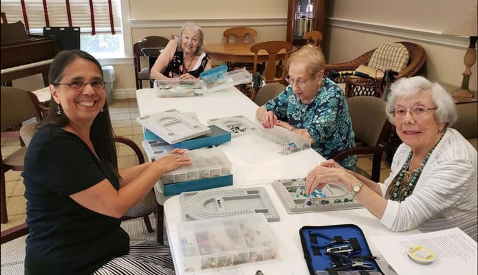 Residents engaging in a crafting activity in a common area