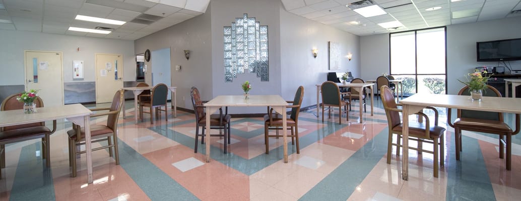 Bright dining room with tables set for meals