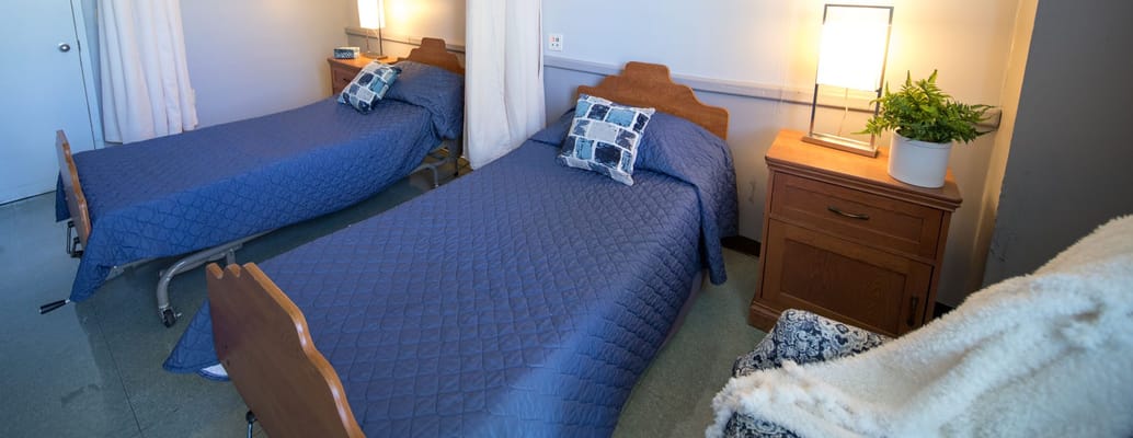 Shared resident room with two beds and bedside tables