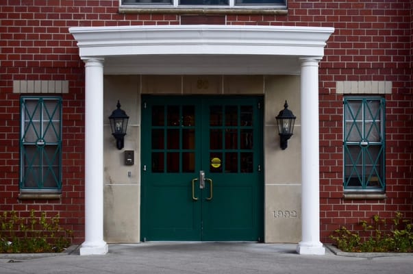 Green double doors with lamps at the entrance of Ridge Street Gardens