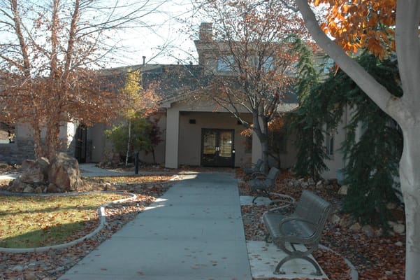 Pathway leading to the entrance of the facility surrounded by trees