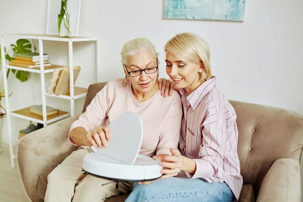 A caregiver and resident interacting with a device