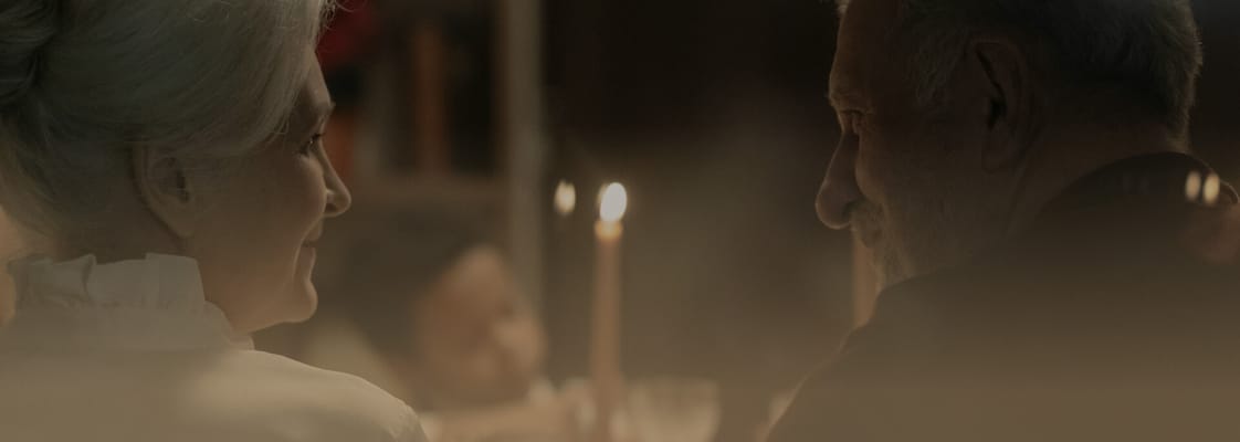 Elderly couple enjoying a candlelit dinner