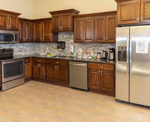 Kitchen area with wooden cabinets and stainless appliances