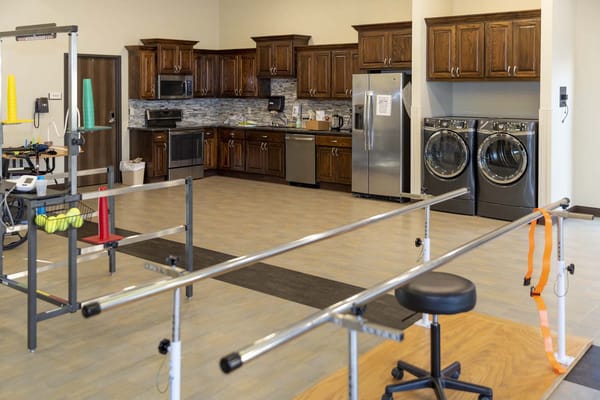 Rehabilitation room with kitchen appliances visible