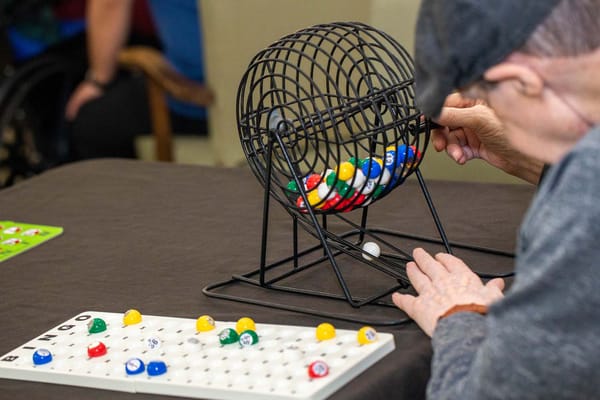 Resident playing bingo at a communal table
