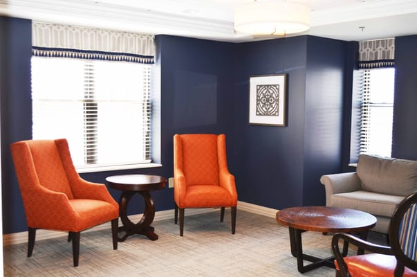Bright interior seating area with orange chairs