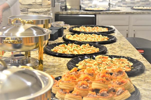 Assorted appetizers displayed on buffet trays