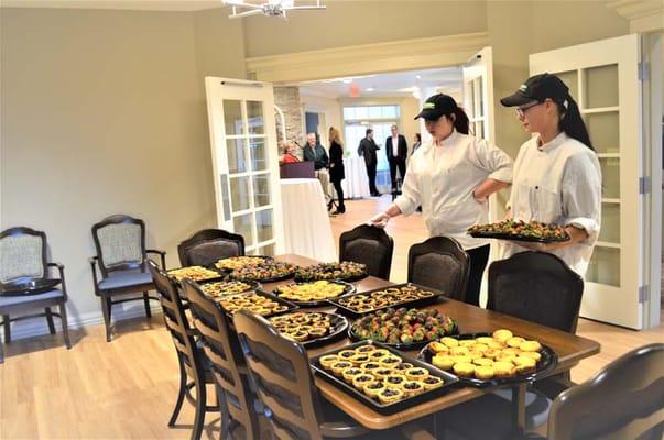 Staff serving food in a dining area