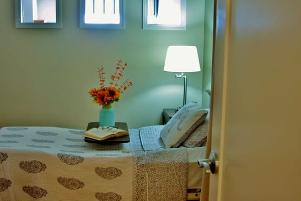 Cozy resident room with a bedside table and flowers