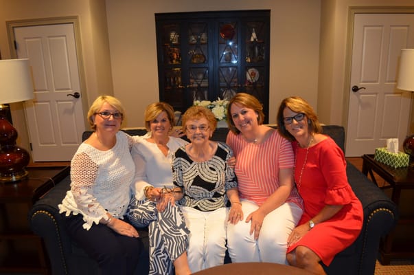 Residents posing together in a cozy lounge area