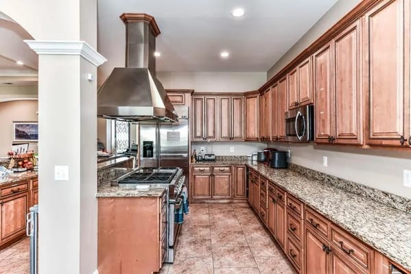 Modern kitchen with wooden cabinets and stainless steel appliances