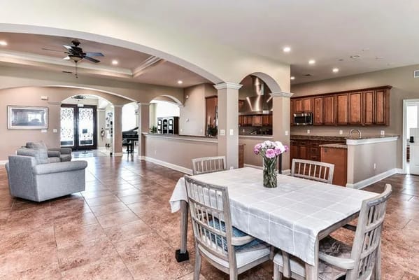 Bright, spacious common area with seating and kitchen access