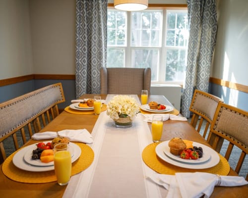 Dining table set with breakfast items and drinks