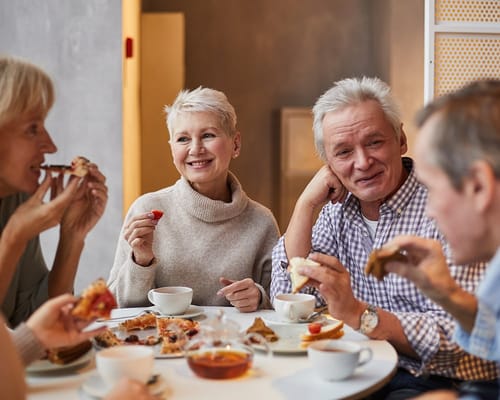 Seniors enjoying snacks and tea in a common area