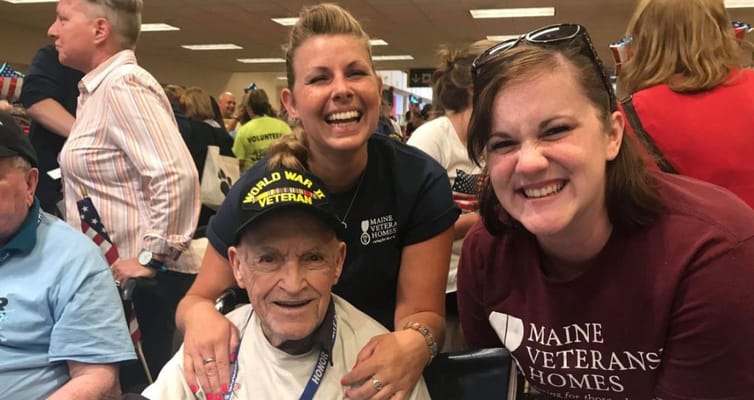 Residents and staff smiling together during an event