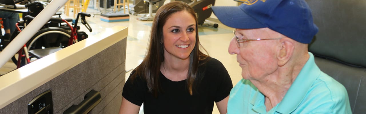 Staff member interacting with a resident in an interior setting