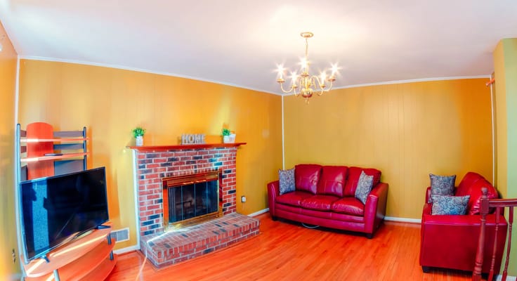 Cozy living room with red sofas and a fireplace