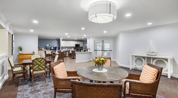 Bright common area with seating and kitchen in the background