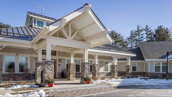 Front entrance of the assisted living facility with stone pillars