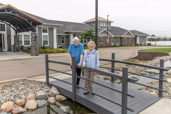 Two residents on a bridge near the facility entrance