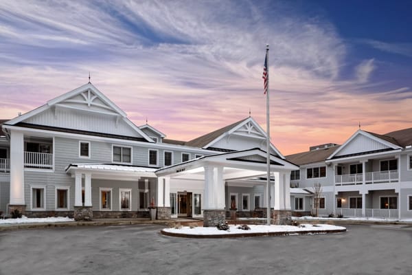 Exterior view of Maplewood at Weston with entrance and flag