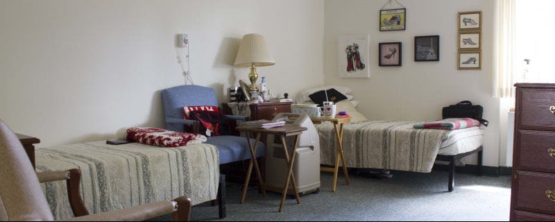 Shared resident room with twin beds and personal items