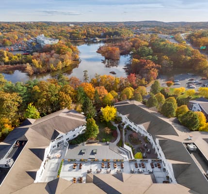 Aerial view of a senior living facility with autumn scenery