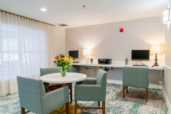Bright common area with computers and seating