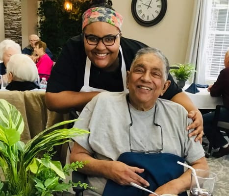 Care staff with a resident in a dining area
