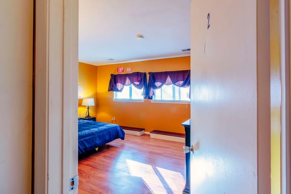 Interior view of a private resident room with orange walls