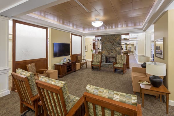 Cozy common area with seating and stone fireplace