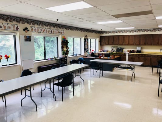 Bright activity room with tables and chairs