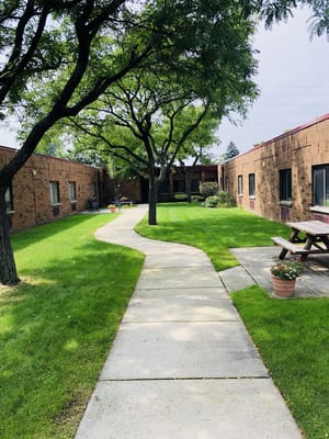 Pathway through landscaped outdoor area of a facility