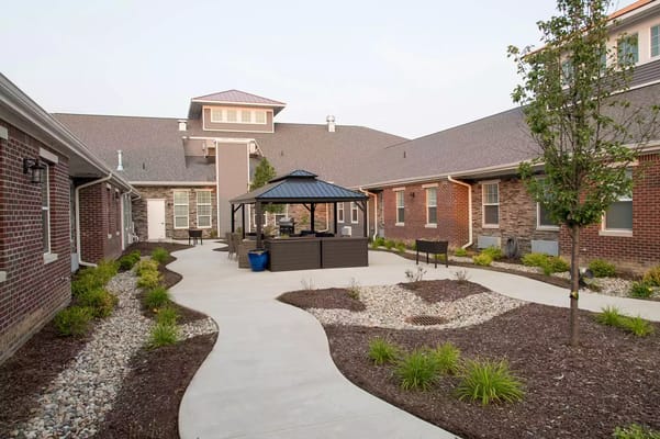 Landscaped outdoor courtyard with gazebo and seating area