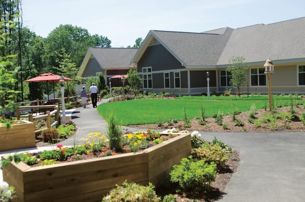 Residents walking in a garden area with walking paths