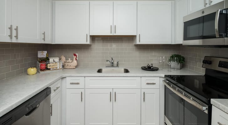 Modern kitchen space with white cabinets and appliances