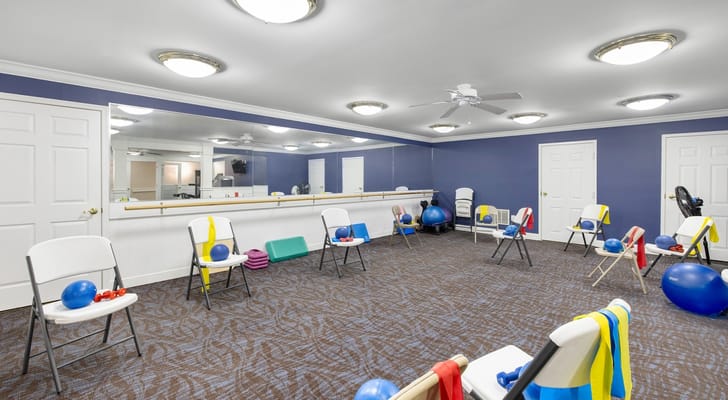 Interior activity room with exercise equipment and seating