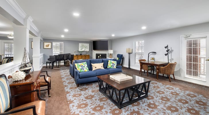 A cozy common area with seating and a piano