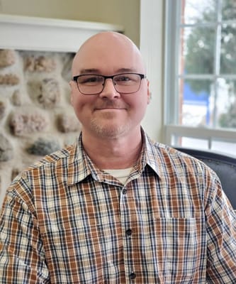 A man sitting indoors at the facility