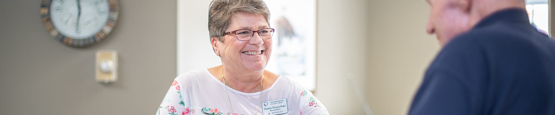 Staff member assisting a resident at the front desk
