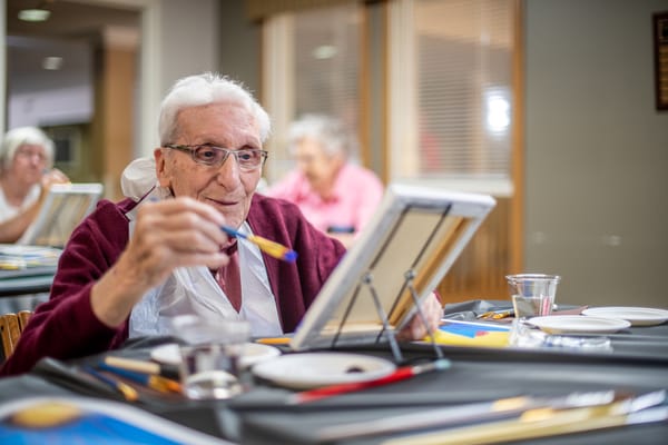 A resident painting during an art activity
