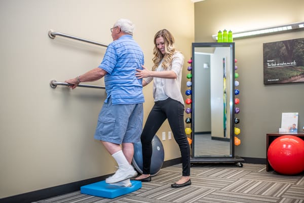 Therapist assisting a resident with balance exercises