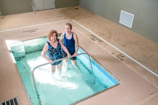 Residents engaging in aquatic therapy in a therapy pool