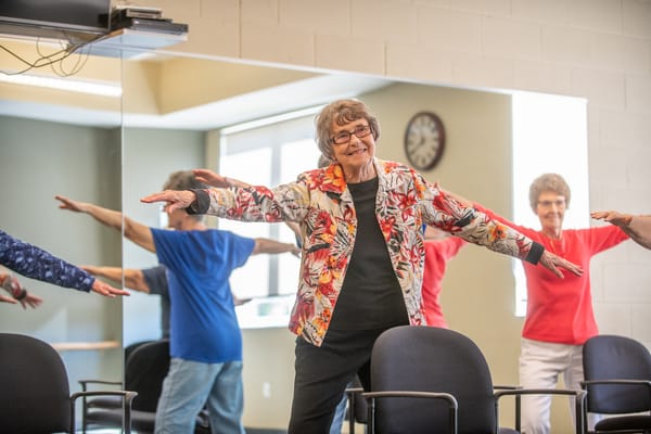 Residents participating in a movement class in a bright room