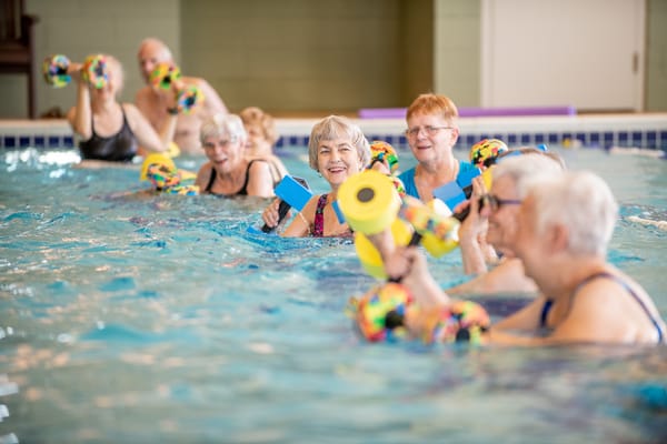 Residents participating in a water aerobics class