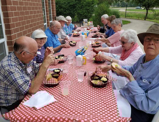 Residents enjoying a meal at an outdoor table