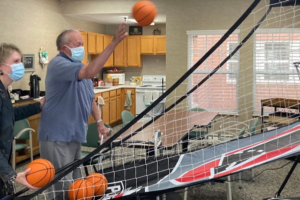 Residents playing basketball in a common area