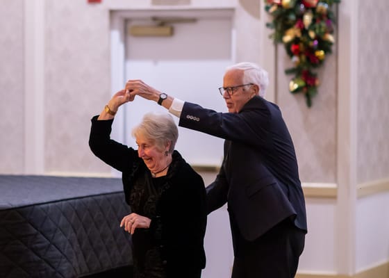 Residents enjoying a dance together at a festivities event.