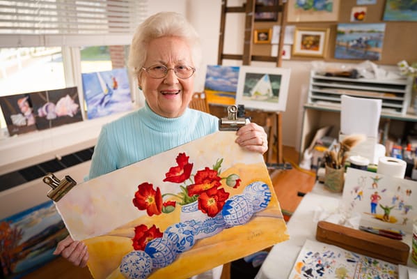 Resident painting flowers in an art room